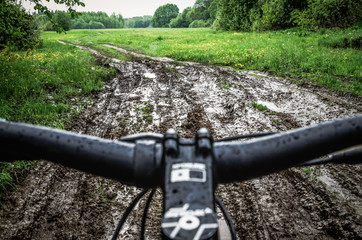 Riding a bike through the mud. Mountain Biker Riding Through A Dirty Puddle