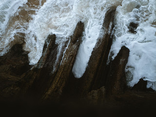 High tide reaching a teeth shaped rock formation