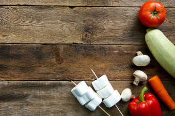  Preparation for barbecue day with friends concept. Vegetables, marshmallow on wooden desk with copy space