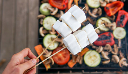  Barbecue on a  wooden terrace concept. Grilled vegetables, marshmallow outdoors