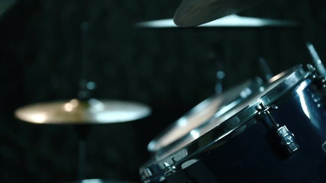 Male Drummer Playing Drums In Dark Room. Close Up