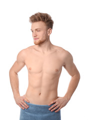 Obraz premium Portrait of young man with slim body in towel on white background