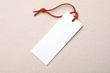 Cardboard tag with space for text on color fabric, top view