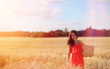 Young girl in a wheat field. Summer landscape and a girl on a nature walk in the countryside.