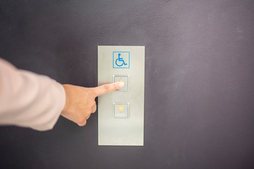 close up woman hand is press elevator button