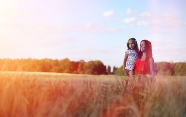 Young girl in a wheat field. Summer landscape and a girl on a nature walk in the countryside.