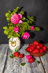 bouquet of red roses and heart on wooden background