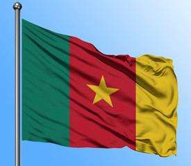 Naklejka premium Cameroon flag waving in the deep blue sky background. Isolated national flag. Macro view shot.
