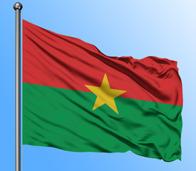 Burkina Faso flag waving in the deep blue sky background. Isolated national flag. Macro view shot.