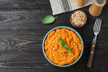 Flat lay composition with mashed sweet potatoes on wooden background, space for text