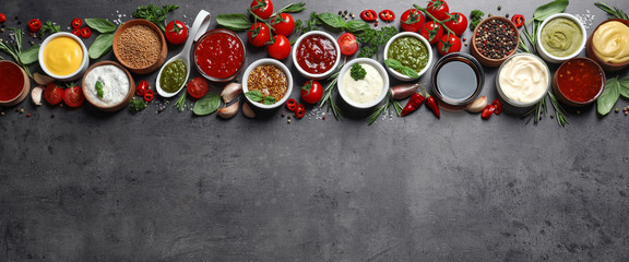 Flat lay composition with different sauces and space for text on gray background - obrazy, fototapety, plakaty