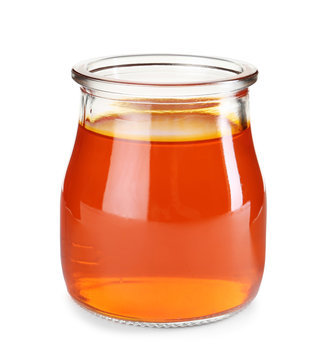Tasty colorful jelly in glass jar on white background