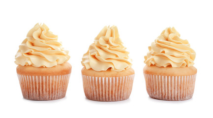 Delicious cupcakes with cream on white background