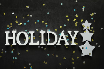 Background concept. The inscription holiday on a dark background.