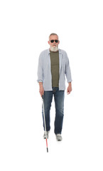 Naklejka premium Mature blind person with long cane walking on white background