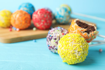 Yummy colorful cake pops on table, closeup. Space for text