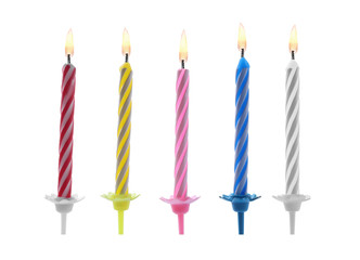 Color birthday cake candles on white background