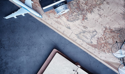 Travel concept. Map on the table andl aircraft.