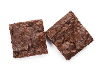 Pieces of fresh brownie on white background, top view. Delicious chocolate pie