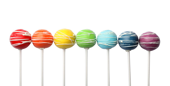 Delicious colorful cake pops on white background, top view