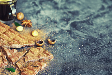 A bar of milk chocolate on the table. Chocolate with nuts and cinnamon.