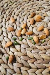 Obraz premium almonds nuts on a natural wicker napkin