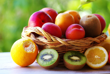 full basket of ripe fruits on table