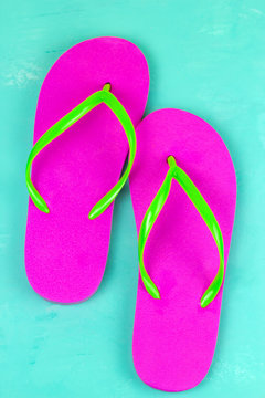 top view bright pink slippers on a blue background