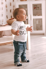 Little boy winner goes to the kids room in jeans and white t-shirt