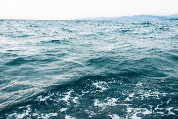 Fototapeta premium dark blue sea water background, waves of blue in black sea