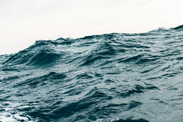 dark blue sea water background, waves of blue in black sea