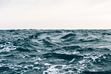 Naklejka na ściany i meble dark blue sea water background, waves of blue in black sea