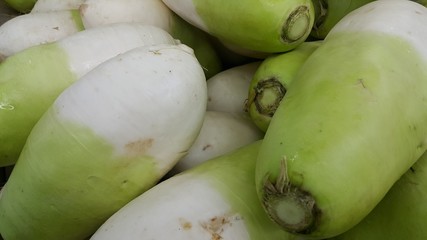 Vegetable background: Large radish pile in supermarket.
