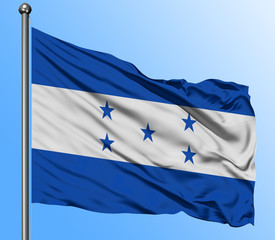 Honduras flag waving in the deep blue sky background. Isolated national flag. Macro view shot.