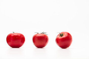  Fresh tasty tomatoes on a white background