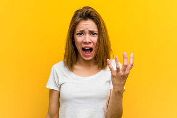 Young natural caucasian woman screaming with rage.