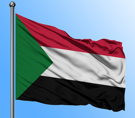 Naklejka na ściany i meble Sudan flag waving in the deep blue sky background. Isolated national flag. Macro view shot.