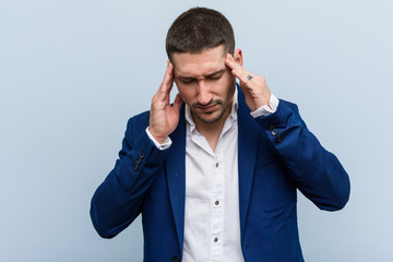 Young business caucasian man touching temples and having headache.