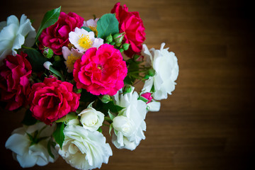 bouquet of beautiful red and white roses on a wooden