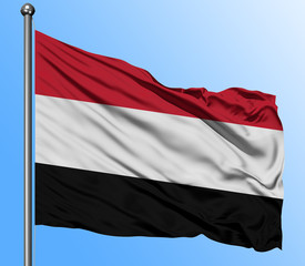 Fototapeta na wymiar Yemen flag waving in the deep blue sky background. Isolated national flag. Macro view shot.