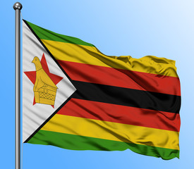 Zimbabwe flag waving in the deep blue sky background. Isolated national flag. Macro view shot.