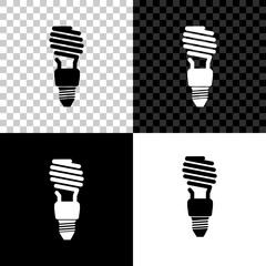 Energy saving light bulb icon isolated on black, white and transparent background. Vector Illustration
