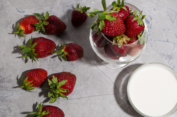 strawberries in a glass on a gray table