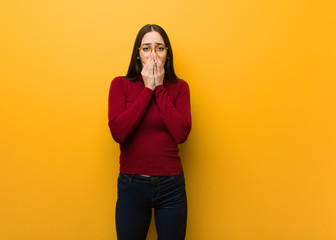 Intellectual young girl very scared and afraid hidden