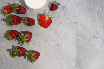 strawberries and cream on a gray table