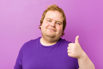 Young authentic redhead fat man smiling and raising thumb up