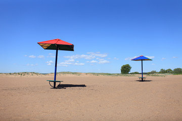 beach dunes sun umbrellas wind no people