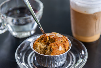 Banana cupcake with ice milk tea and water drink