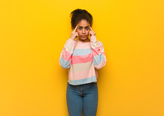 Young black african american girl with blue eyes doing a concentration gesture