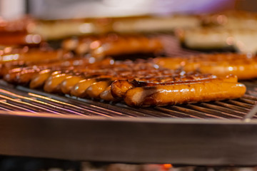 Process of cooking hotdogs at street food festival. Outdoor cooking service gastronomy and takeaway food concept